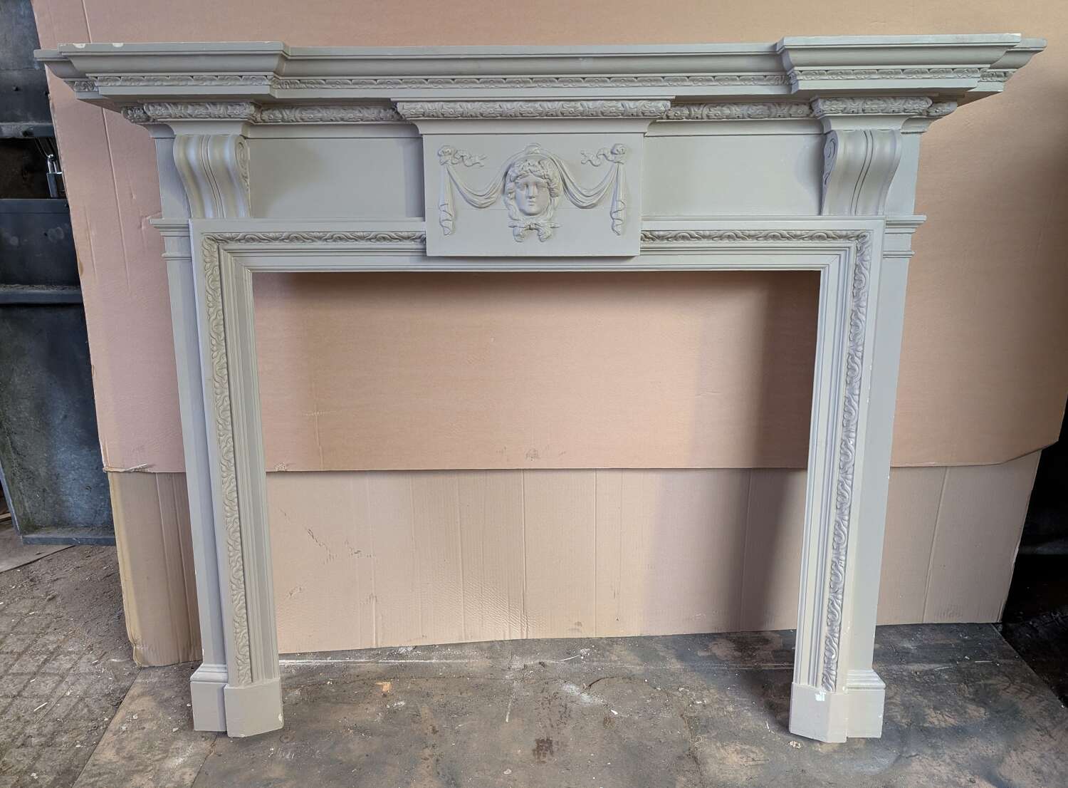 A LARGE RECLAIMED ANTIQUE PAINTED PINE FIRE SURROUND WITH MARBLE SLIPS